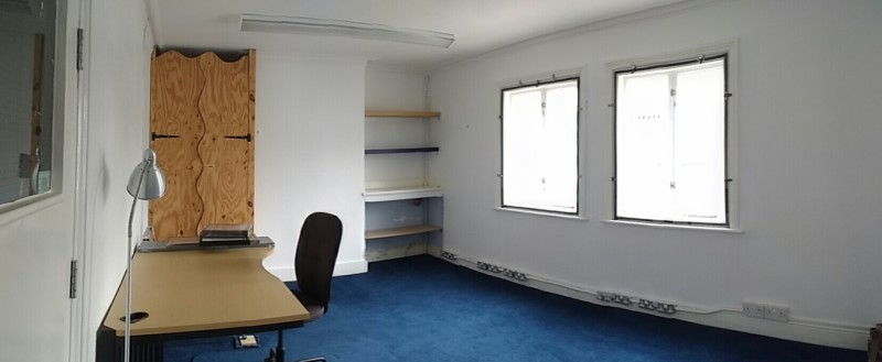 Office with desk, windows and carpet