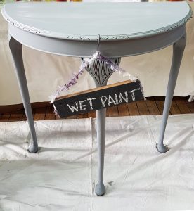 Side table in chalk paint with wet paint sign