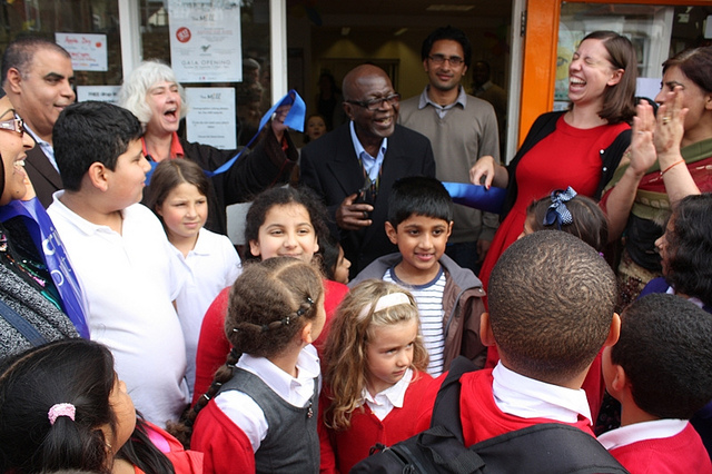 Mr Mensah opening The Mill surrounded by school children, Mill volunteers and local councillors