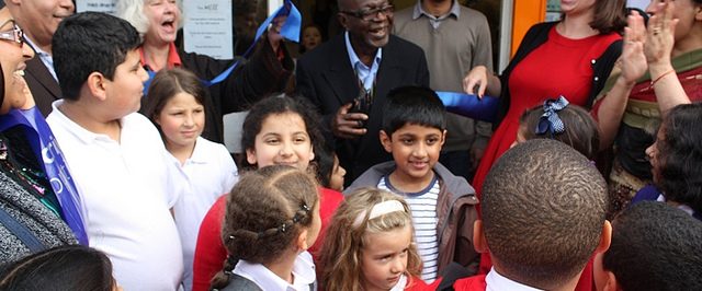 Mr Mensah opening The Mill surrounded by school children, Mill volunteers and local councillors